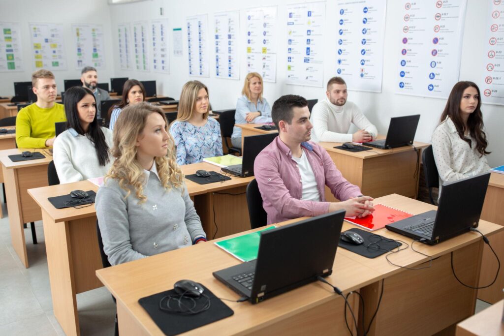 Modern classroom inside a premium digital marketing institute. Instructor teaching Google Ads strategy using projector while students actively participate. Editorial photography, realistic expressions, professional educational atmospheModern classroom inside a premium digital marketing institute. Instructor teaching Google Ads strategy using projector while students actively participate. Editorial photography, realistic expressions, professional educational atmosp