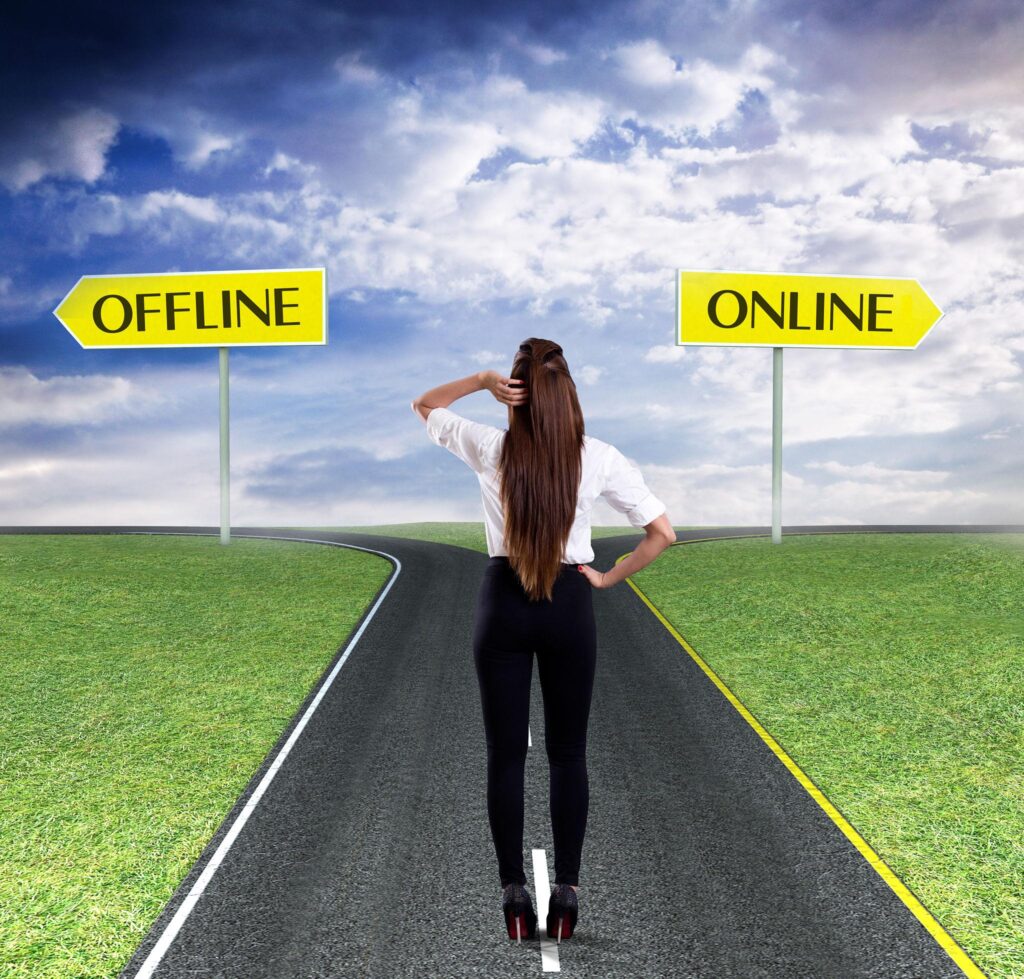 Young professional standing in front of two pathways labeled conceptually as online learning and classroom learning. Modern educational environment, confident expression, realistic editorial photography, shallow depth of field, premium lighting, symbolic career decision.